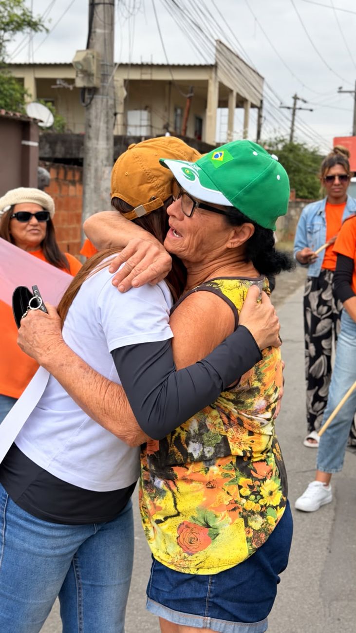Moradora de boné verde abraça Kelaine na rua